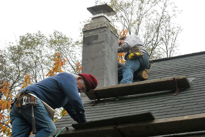 Master Craftsmen Installing Lead Chimney Counter-Flashing Mortar Joint Rebuild in Virginia Beach